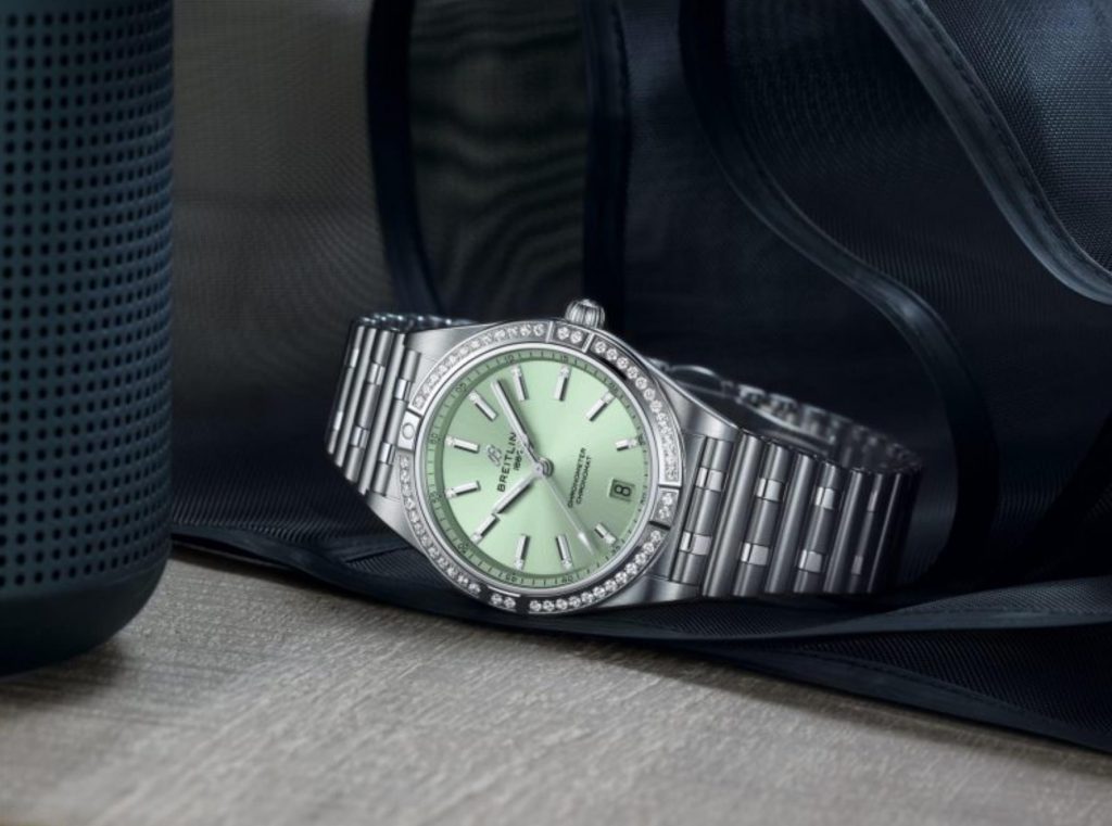 The stainless steel fake watch has a mint green dial.